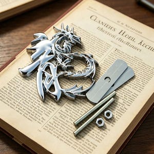 May include: A polished chrome dragon emblem with Chinese characters rests on an open book. Metal hardware, including bolts, nuts, and small metal plates, are also present. The book's pages are aged, with visible text.