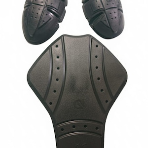 May include: Black motorcycle armor set, including two shoulder pads and a back protector. The pads have a textured surface with a grid pattern and small ventilation holes. The back protector is shaped to fit the spine.