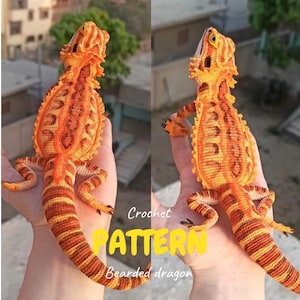May include: Crocheted bearded dragon in shades of orange and yellow, held in a hand. The crochet work features detailed patterns and textures, with the text "Crochet PATTERN Bearded dragon" in yellow.