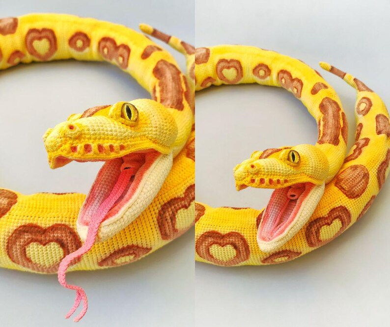 May include: A crocheted snake in yellow and brown, featuring heart-shaped patterns. The snake's mouth is open, showing a pink interior and a pink tongue. The eyes are yellow.