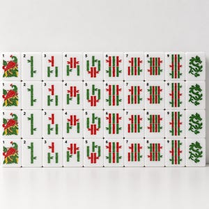 May include: A set of white rectangular mahjong tiles arranged in four rows. The tiles feature green and red bamboo patterns numbered one through nine, along with tiles displaying a red bird illustration and a green dragon symbol on the ends.