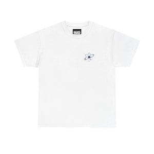 May include: White t-shirt with a small atom graphic in blue and gray on the front. The shirt also features the text "BEATS" in a small black rectangle near the neckline. The t-shirt is made of a soft, comfortable material.
