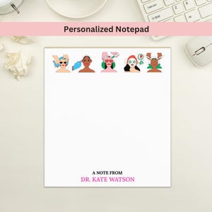 May include: A white personalized notepad with a pink header that reads "Personalized Notepad." The notepad features illustrations of people receiving spa treatments. The bottom of the notepad reads "A note from Dr. Kate Watson."