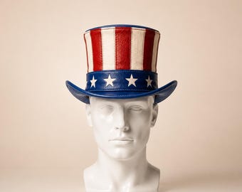 May include: An Uncle Sam-style hat with a red, white, and blue colour scheme. The crown has red and white stripes, and the brim is blue with white stars. The hat is displayed on a white mannequin head.