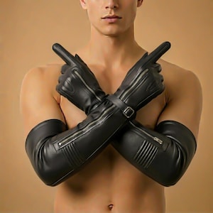 May include: Black leather gloves with long sleeves, featuring zippers and a buckle closure. The gloves are designed with ribbed detailing and are shown with the arms crossed.