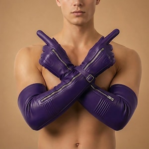 May include: A pair of long, purple leather gloves with silver zippers and a buckle closure. The gloves are designed to cover the hands and forearms, with a sleek, modern aesthetic. The gloves are a vibrant shade of purple.