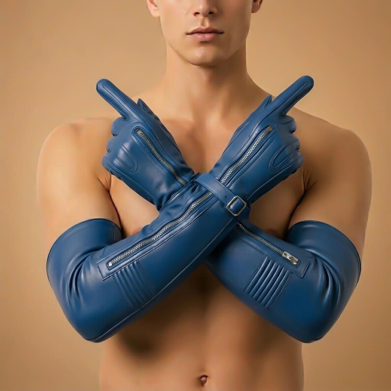 May include: Blue leather gloves with long sleeves, featuring silver zippers and a buckle closure. The gloves are designed with a sleek, modern aesthetic. The gloves are a vibrant shade of blue.