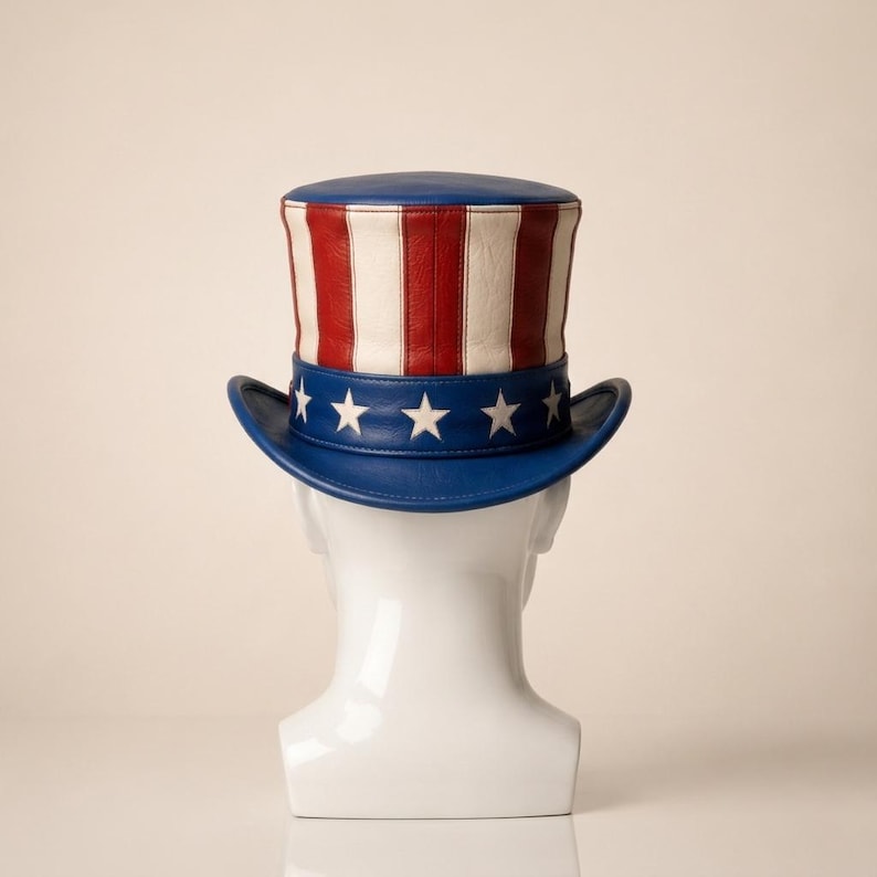 May include: A patriotic Uncle Sam hat with a blue brim and crown, featuring red and white stripes on the crown. The hat has a blue band with white stars. A classic American symbol.