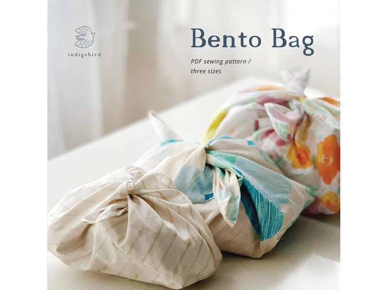 May include: Three colorful Bento Bags, tied with knots, are displayed on a white surface. The bags feature floral and abstract patterns in shades of blue, orange, and green. The text "Bento Bag" and "PDF sewing pattern / three sizes" is visible.