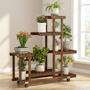 Rustic wood plant stand with lockable wheels parked next to a window
