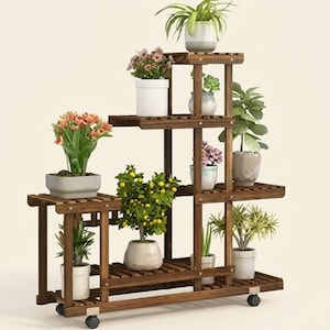 Multi-tier wood plant stand holding potted plants against a clean white background