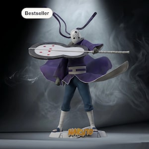 May include: A detailed figurine of a character from the Naruto anime series. The figure is wearing a purple cloak, blue pants, and a white mask. It holds a large, gray weapon. The base reads "Naruto" in orange letters. The word "Bestseller" is in a white oval.