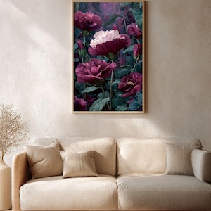 May include: A framed floral print featuring large, deep burgundy flowers with white accents against a dark green background. The artwork is displayed above a beige sofa with matching pillows, creating a serene living room scene.