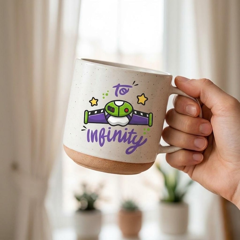 May include: A speckled off-white ceramic mug with a natural clay base. The front features a graphic of a purple, green, and white space ranger chest plate with yellow stars and the purple text To Infinity written in a cursive script font.
