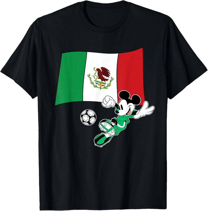 May include: Black t-shirt featuring a graphic of Mickey Mouse in a soccer uniform kicking a soccer ball. The Mexican flag is behind Mickey. The flag is green, white, and red with the Mexican coat of arms in the center.