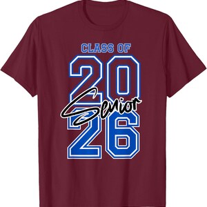 May include: Burgundy t-shirt with the text "CLASS OF 2026 SENIOR" in blue and white. The numbers "20" and "26" are large and outlined in blue. The word "Senior" is in a cursive font.