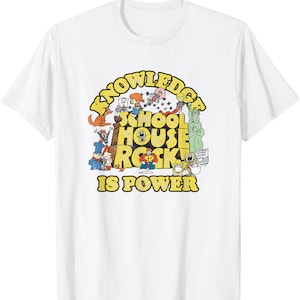 May include: White t-shirt featuring a colorful graphic from Schoolhouse Rock. The design includes the text "Knowledge School House Rock Is Power" in yellow, with various cartoon characters and illustrations.