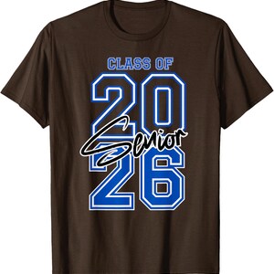 May include: Brown t-shirt with the text "CLASS OF 2026 Senior" in blue and white. The word "Senior" is in a cursive font. The shirt is a classic crew neck style.