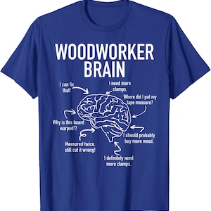 Op de afbeelding: Blauw t-shirt met de tekst "WOODWORKER BRAIN" en een hersengrafiek. De grafiek bevat tekst als "Ik heb meer klemmen nodig" en "Waar is mijn meetlint?"