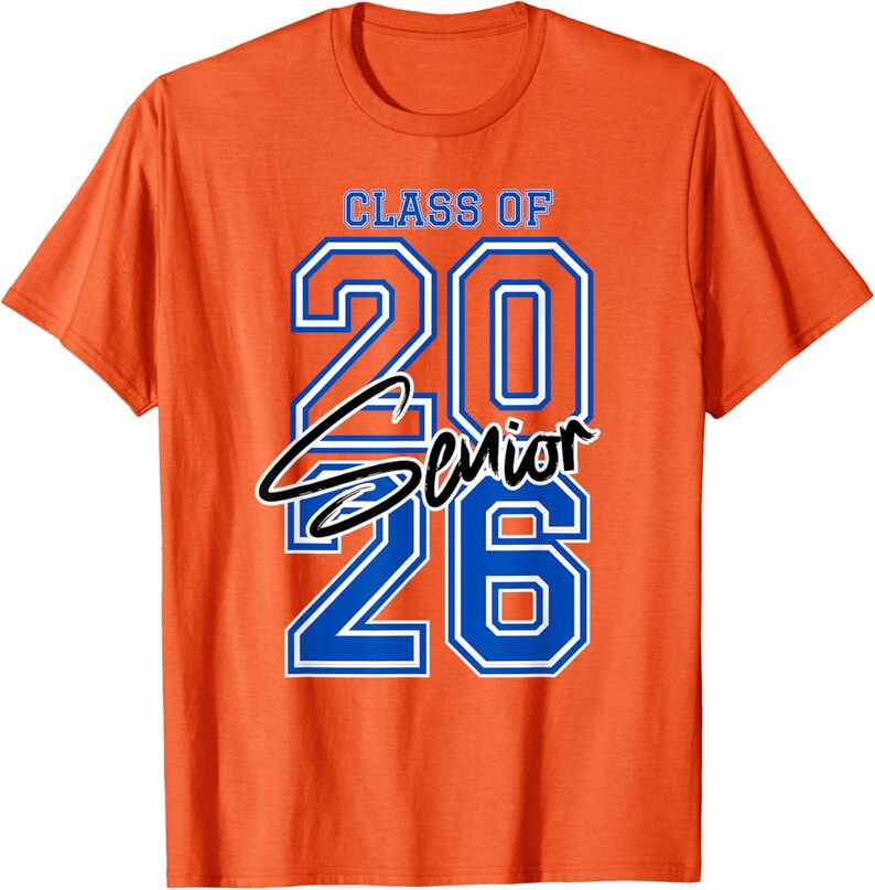 May include: Orange t-shirt with the text "CLASS OF 2026 Senior" in blue and white. The word "Senior" is in a cursive font. The shirt is a crew neck style.