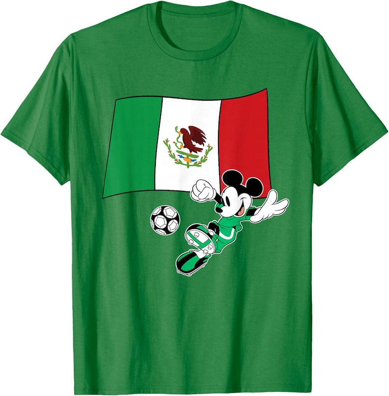 May include: Green t-shirt featuring a graphic of Mickey Mouse playing soccer in a green uniform. The design includes the Mexican flag and a soccer ball. The shirt is made of a soft material.