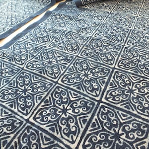 May include: A blue and white fabric with a repeating geometric pattern. The fabric is folded in half and the pattern is visible on both sides.