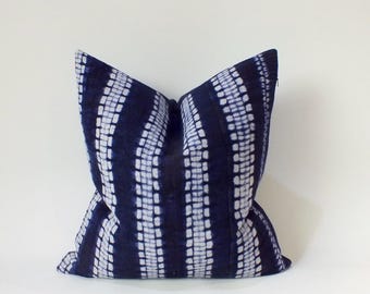 May include: A blue and white patterned pillow cover with a tie-dye design. The pillow cover is made of a soft, comfortable fabric and is perfect for adding a touch of style to any room.