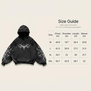 May include: Black hoodie with a unique white graphic design on the front, sleeves, and hood. The hoodie has a front pocket and a size guide with measurements in inches. The chest measurements range from 40.9 to 45.7 inches.
