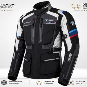May include: A black, grey, and white motorcycle jacket featuring the BMW logo on the chest and sleeve, with blue and red accent stripes on the arm, multiple zipped pockets, a high collar, and adjustable straps at the waist and sleeves.