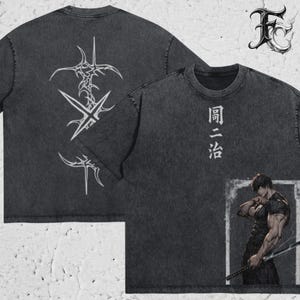 May include: A charcoal grey acid-wash t-shirt featuring a back graphic of white tribal-style thorn patterns. The front displays vertical Japanese text and a rectangular frame containing an illustration of a muscular figure holding a sword.