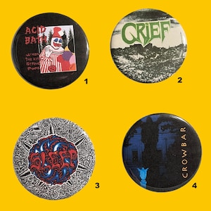 May include: Four round pinback buttons with unique designs. One features a clown and the text "Acid Bath". Another says "Grief" in green. A third has "Sleep" in red and blue. The last says "Crowbar" with a blue silhouette.