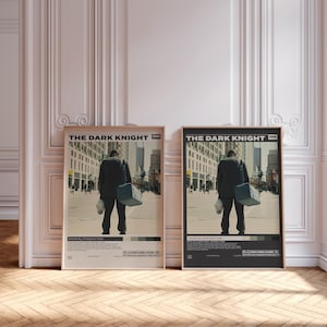 May include: Two framed movie posters for The Dark Knight 2008. Each poster features a central image of a person in a dark suit carrying a bag and a mask, walking down a city street. The text includes the title, director, and production details.