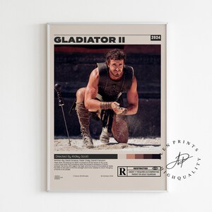 Könnte beinhalten: Gerahmtes Filmplakat für "Gladiator II" mit einem knienden Mann in römischer Rüstung. Das Poster hat einen beigen Hintergrund mit dem Filmtitel und dem Jahr 2024 oben. Das Poster ist mit R bewertet.
