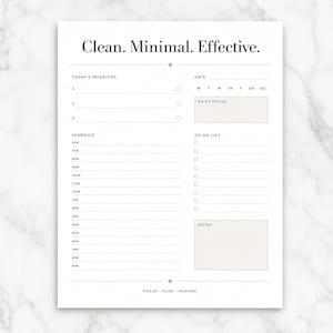 May include: A white daily planner page with black text featuring the header Clean. Minimal. Effective. It includes sections for Today's Priorities, Date, Daily Focus, a schedule from 6AM to 9PM, a To-Do List, and a Notes box with the footer Focus - Plan - Achieve.