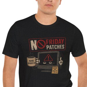 May include: A black short-sleeve t-shirt featuring a graphic of a computer monitor with a warning symbol, holding a coffee mug labeled "MAYBE MONDAY-GIN" and a note saying "FUTURE ME WILL FIX IT". The text above reads "NO FRIDAY PATCHES".