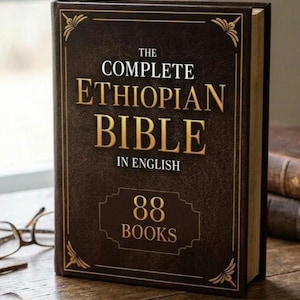 May include: A hardcover book titled "The Complete Ethiopian Bible in English" with gold lettering and accents. The book cover is dark brown with the text "88 Books" in a rectangular frame. The book is on a wooden surface.
