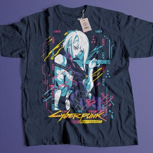 May include: Navy blue t-shirt featuring a graphic of a female anime character with white hair and a futuristic design. The text "Cyberpunk Edgerunners" is displayed in yellow and white. The shirt has a tag that says "LARGE".