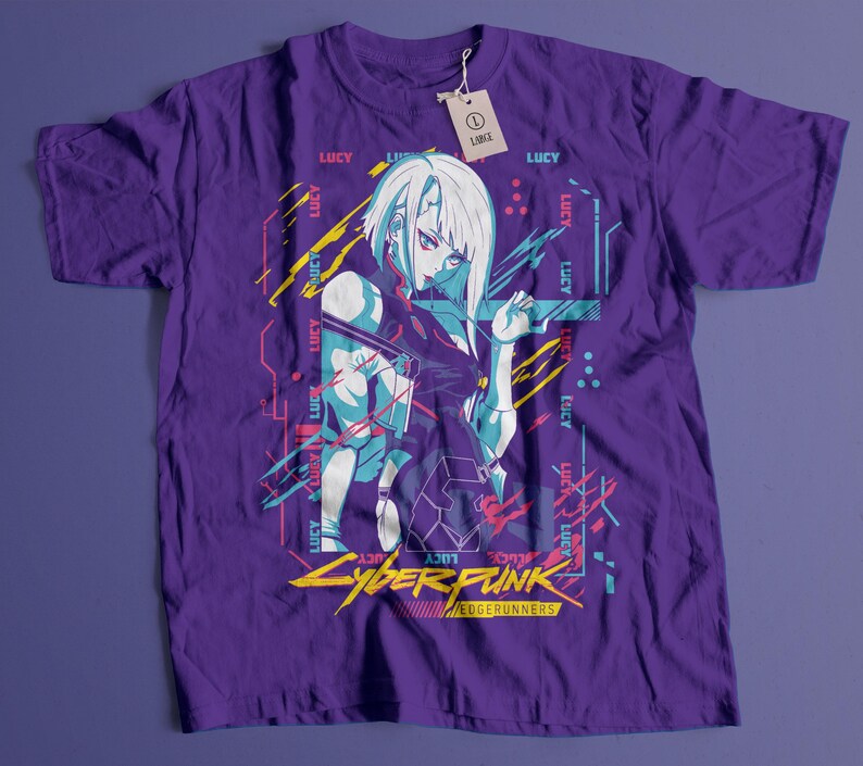 May include: Purple t-shirt featuring a graphic of a female anime character with white hair and blue accents. The shirt has the text "LUCY" and "CYBERPUNK EDGERUNNERS" in yellow and pink. A tag reads "LARGE".