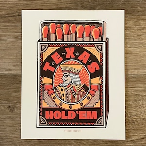May include: A rectangular print featuring a matchbox design with the words "TEXAS HOLD'EM" and an illustration of a king. The artwork uses a color palette of orange, brown, and black.