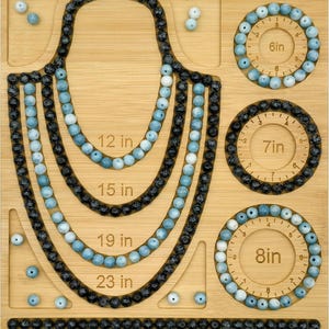 May include: A bamboo jewelry design board featuring U-shaped channels for necklaces labeled 12 in, 15 in, 19 in, and 23 in, plus three circular channels for bracelets labeled 6in, 7in, and 8in, and a straight ruler at the bottom marked up to 8.5 inches.