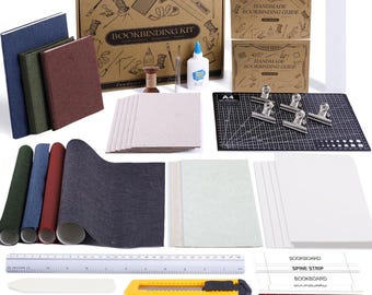 May include: A comprehensive bookbinding kit featuring a cardboard box labeled BOOKBINDING KIT, three bound books in blue, green, and red, a black A4 cutting mat, metal clips, white glue, a ruler, a yellow utility knife, needles, and paper.