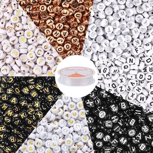 May include: A collection of round alphabet beads in various color combinations including white with gold letters, white with silver letters, black with gold letters, and black with silver letters, plus white heart beads and a spool of 0.8mm elastic string.