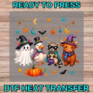 May include: A DTF heat transfer sheet featuring a Halloween-themed graphic with a ghost, a duck, a raccoon, and a highland cow wearing costumes. Above them hangs a string with stars, moons, bats, and leaves. A pumpkin sits at the bottom.
