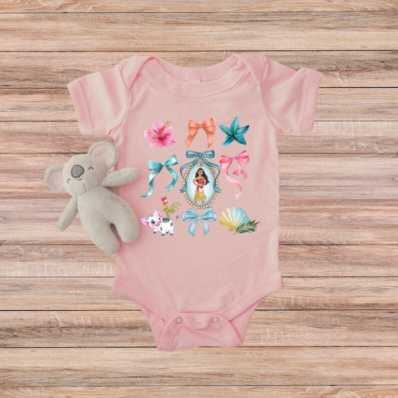 May include: Pale pink baby bodysuit decorated with vibrant bows, a starfish, a seashell, and a framed character illustration. A stuffed koala toy is next to the bodysuit. The design has a tropical theme.