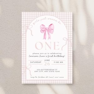May include: A pink and white gingham patterned birthday invitation with a pink bow and the word "ONE". The invitation includes the text "girls just wanna be" and details for a first birthday celebration.