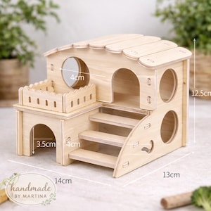 May include: A multi-level wooden hamster house with a natural finish. Features include a small balcony, stairs, and multiple circular openings. Dimensions are 14cm long, 13cm wide, and 12.5cm high. The house has a 4cm diameter opening and a 3.5cm wide entrance.