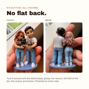 May include: A custom figurine set featuring two figures standing on a blue oval base. The figures have detailed hair, blue jeans, and white shoes. One figure wears a brown top, the other a white t-shirt. They hold a black cat and a tabby cat.