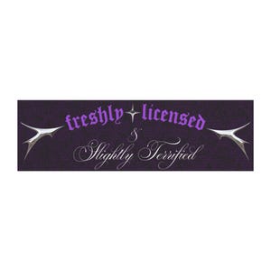 May include: A rectangular purple graphic with the words "freshly licensed & Slightly Terrified" in stylized fonts. Two silver, wing-like shapes flank the text. The background has a textured appearance.