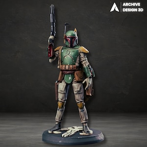 May include: A detailed figurine of Boba Fett, a character from Star Wars, stands on a round base. The figure is clad in green, brown, and tan armour, holding a blaster. The helmet is green with red accents. The Archive Design 3D logo is in the upper right corner.