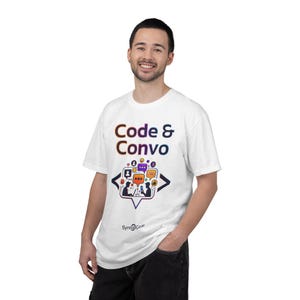 May include: White t-shirt featuring the text "Code & Convo" in a gradient of colours. Below the text is a graphic of two people communicating via speech bubbles and icons. The brand name "Synt@Gear" is printed below the graphic.